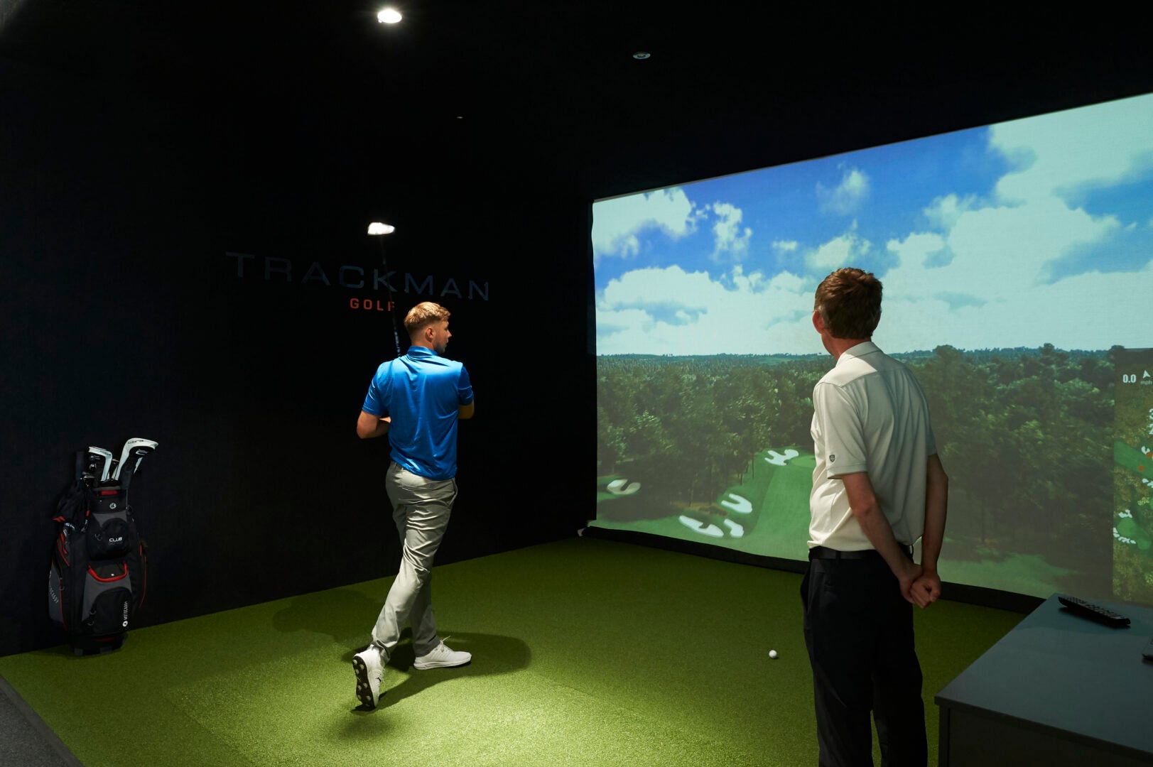 guy swinging golf club using golf simulator at mattishall golf club